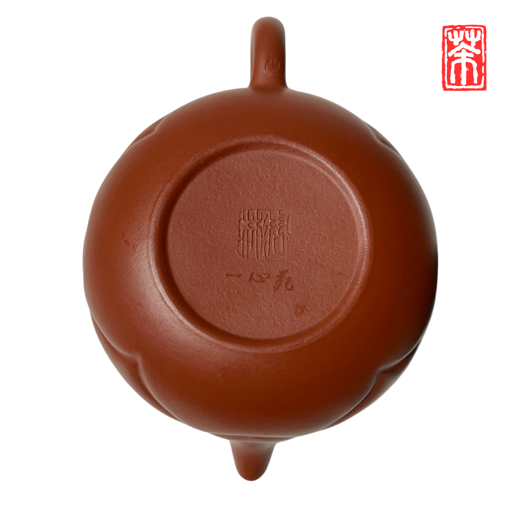 Ergänzen Sie Ihre Teekollektion mit dieser eleganten Yixing-Teekanne aus rötlichem Zisha-Ton. Die lebendige, helle Tonfarbe und das kunstvoll eingearbeitete Wolkenrelief machen sie zum Blickfang – perfekt, um die erdigen Aromen von Pu-Erh und dunklen Tees stilvoll zu genießen.