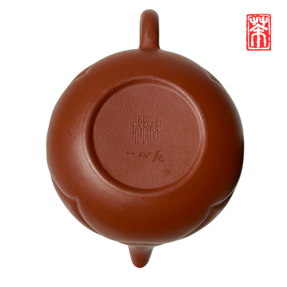 Ergänzen Sie Ihre Teekollektion mit dieser eleganten Yixing-Teekanne aus rötlichem Zisha-Ton. Die lebendige, helle Tonfarbe und das kunstvoll eingearbeitete Wolkenrelief machen sie zum Blickfang – perfekt, um die erdigen Aromen von Pu-Erh und dunklen Tees stilvoll zu genießen.